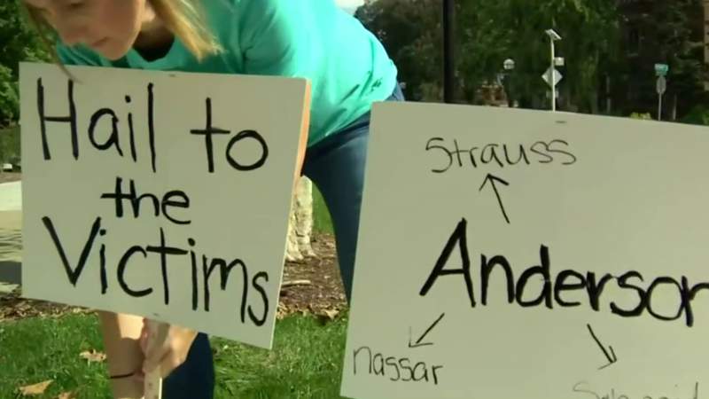 Survivors of abuse protest outside University of Michigan president’s home