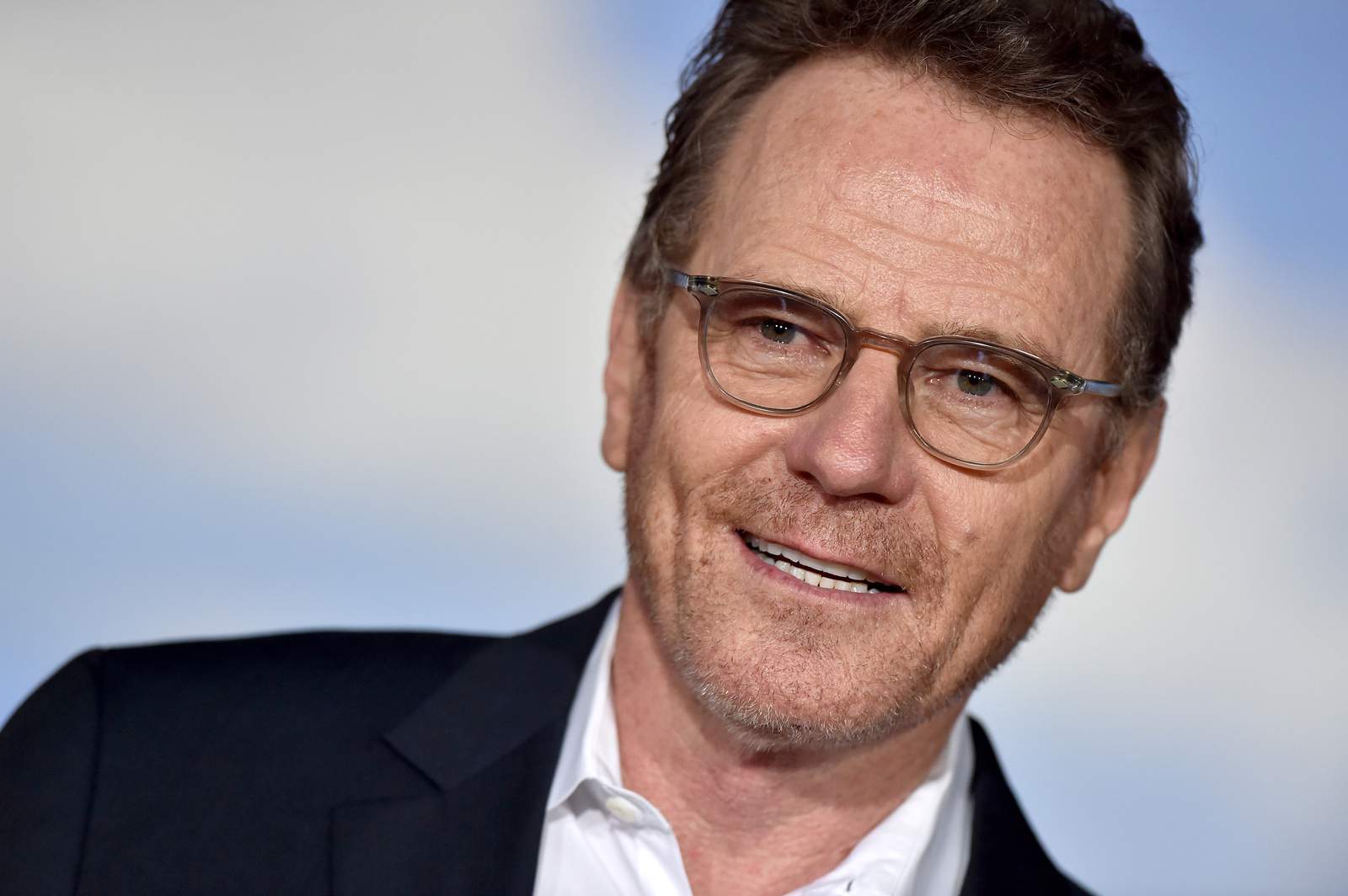 Actor Bryan Cranston wears a Walter White mask onstage at the