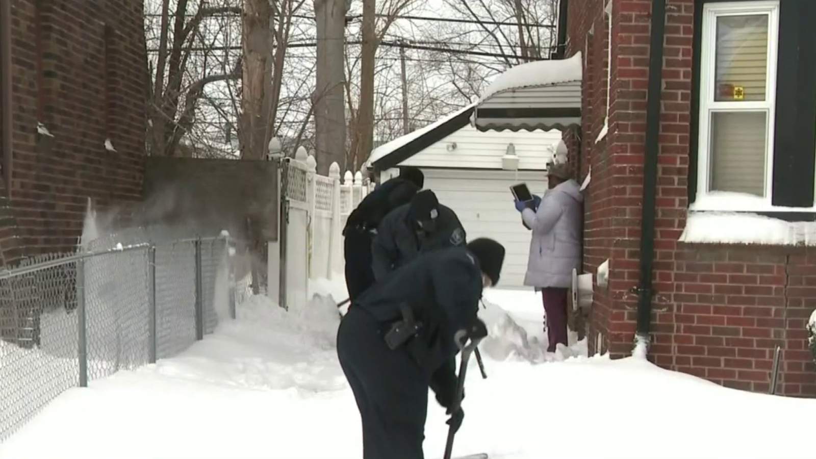 Detroit officers help seniors shovel snow after winter storm