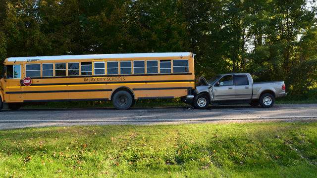 Pickup truck driver dies after crashing into back of stopped school bus in Lapeer County, police say