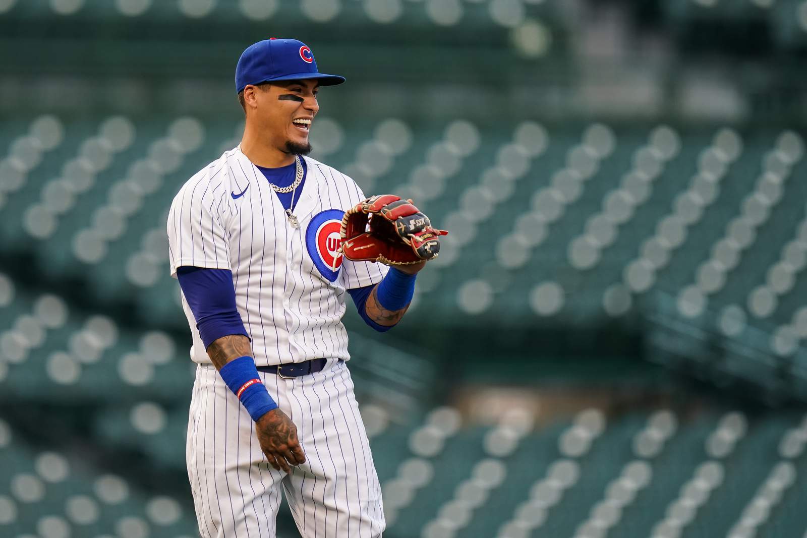 Cubs SS Javy Baez tosses bat past mound on strikeout, sails throw over first base into stands