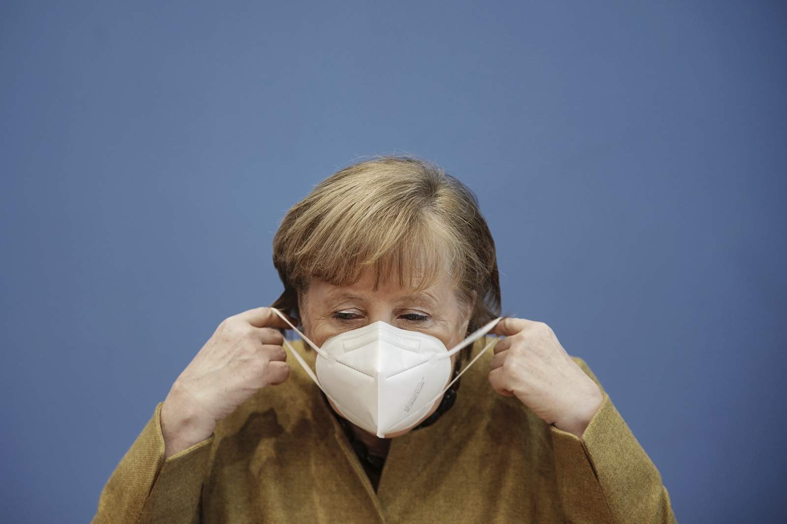 Germany's Merkel points to variant risk as infections drop