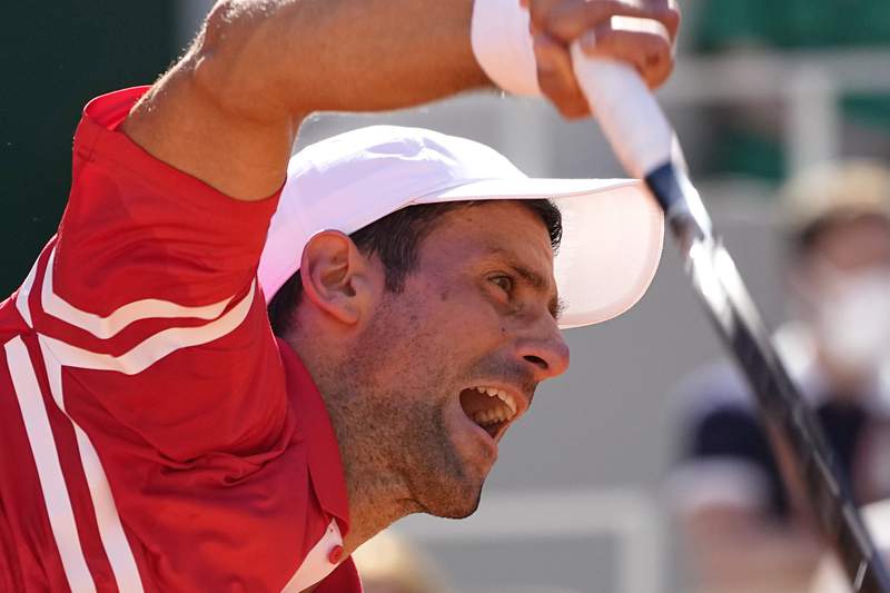 The Latest: Djokovic rallies for his 2nd French Open title