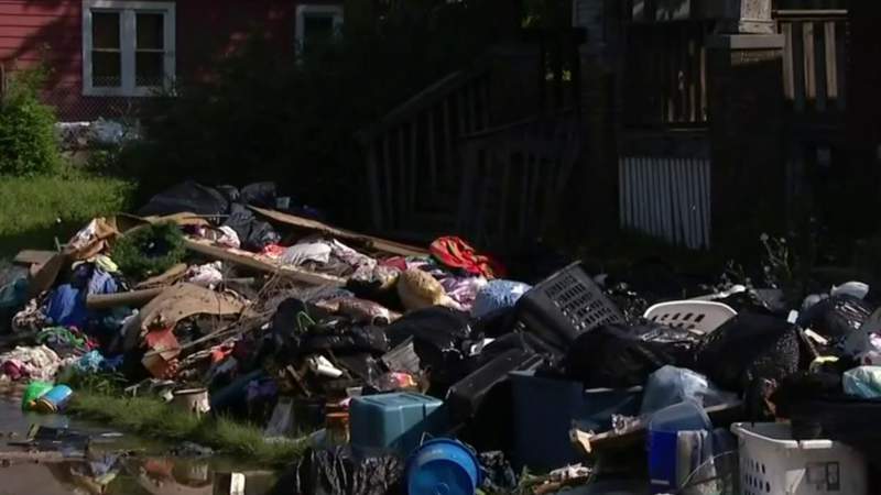 Detroit cleans up pile of trash along Hazlett Street in Detroit left from June flooding