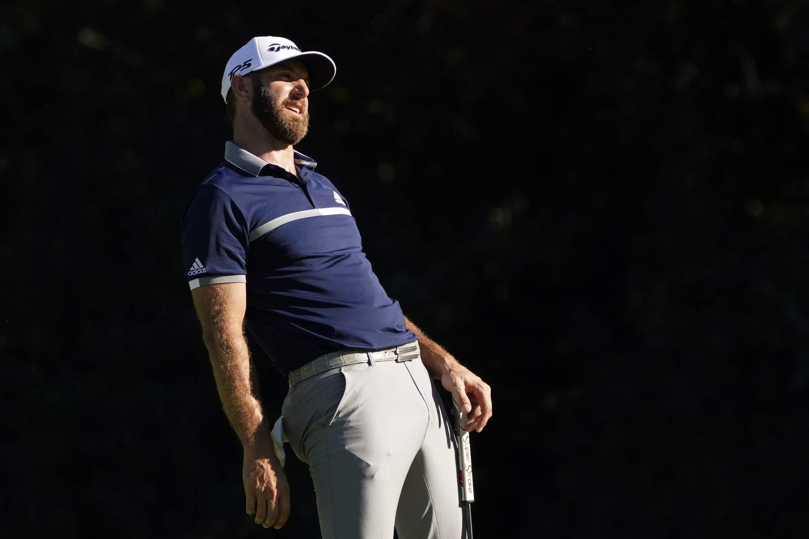 The Latest: Johnson shares Masters lead, play suspended