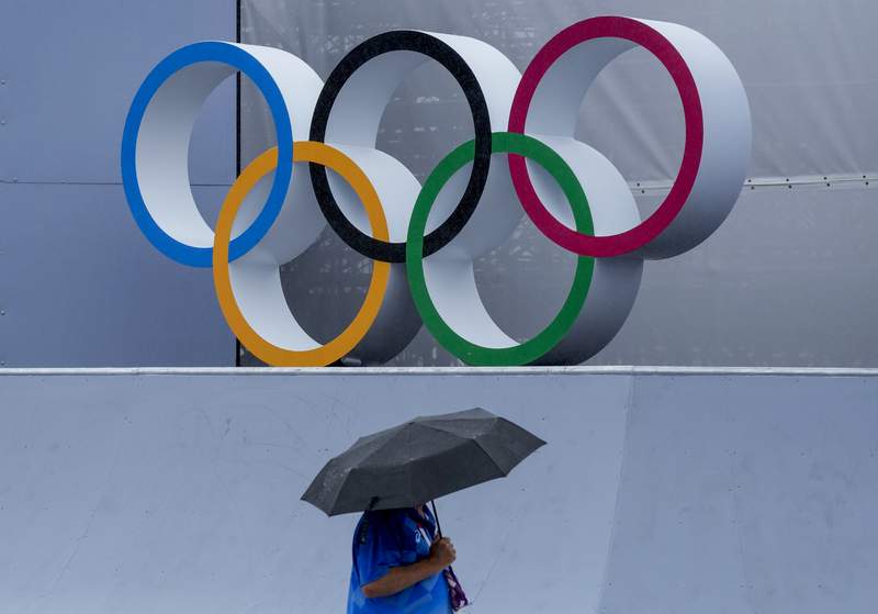 GLIMPSES: As rain arrives and typhoon nears, Olympics endure