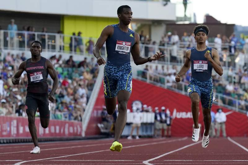 The Latest: Teen turns in fastest time in semis of 200