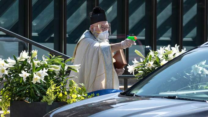 Detroit priest goes viral after squirting socially-distanced blessings from a water gun