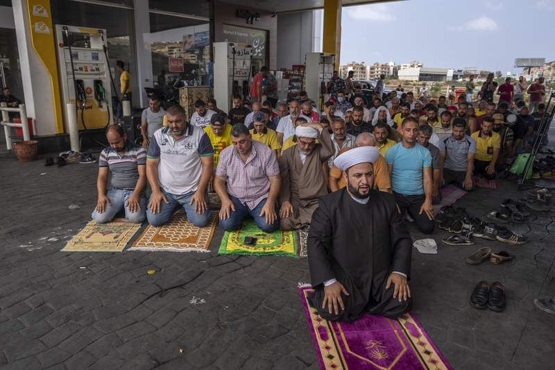 Worshippers pray at gas station in Lebanon amid fuel crisis