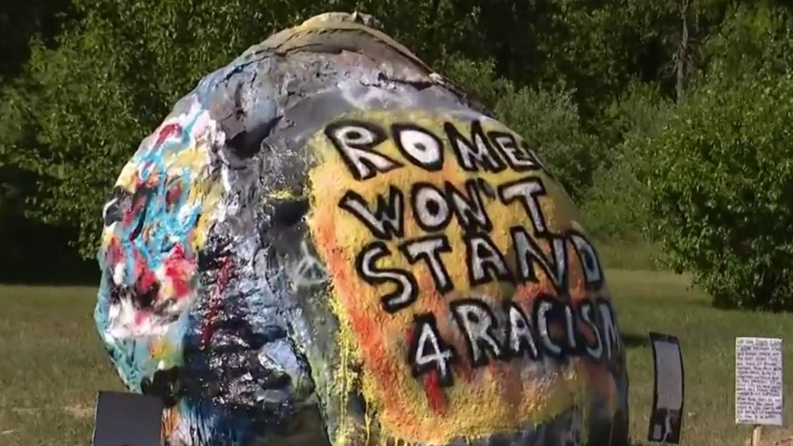 Romeo community comes together to promote peace after racial slurs painted on iconic rock